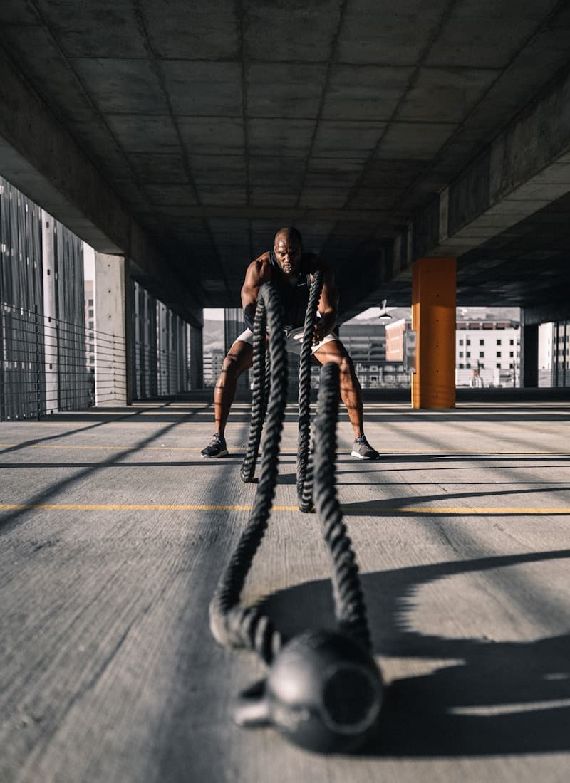 Athlete training with battle ropes — intensity and focus