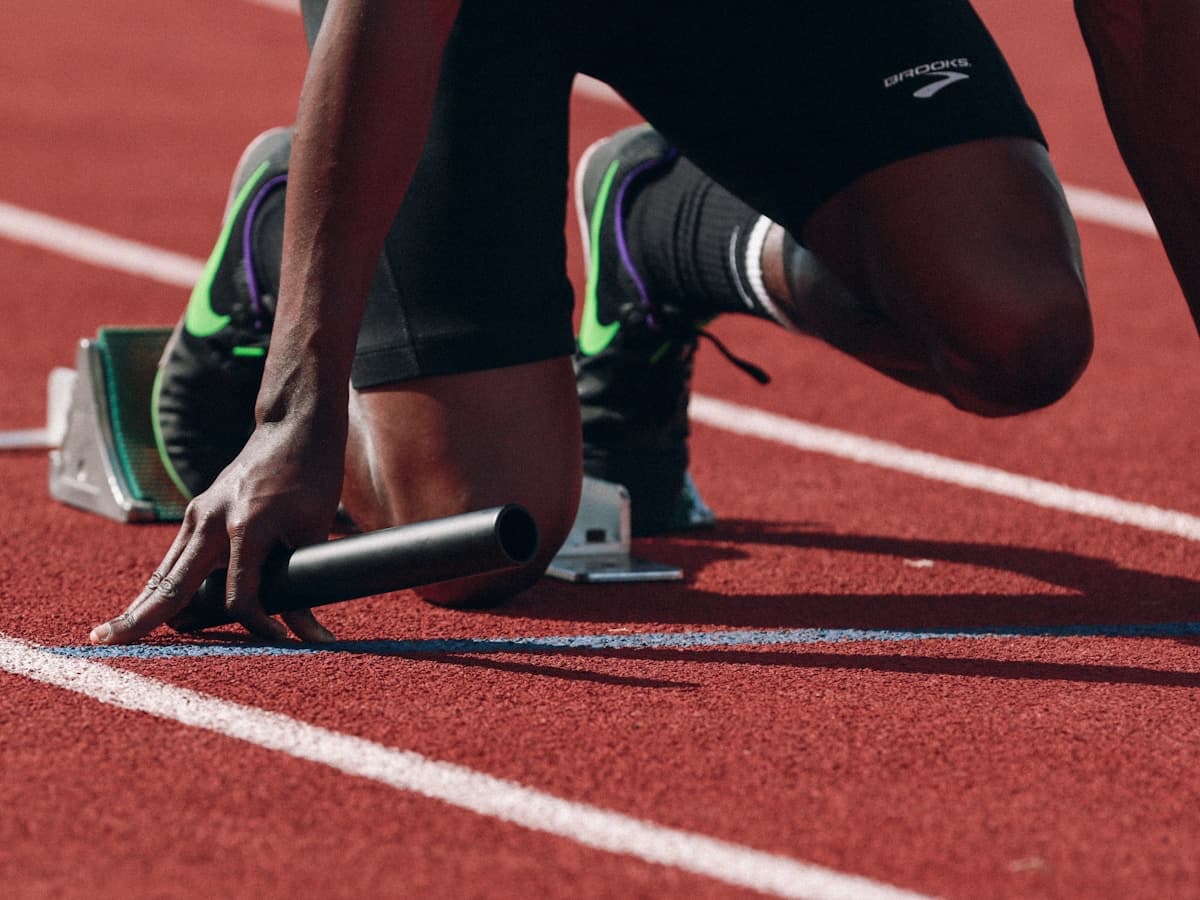 Athlete at starting blocks on track