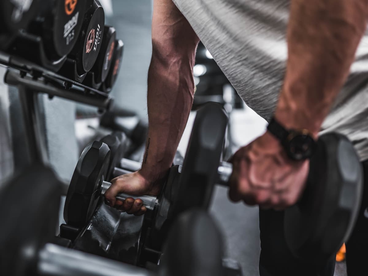 Hands gripping dumbbells — the details